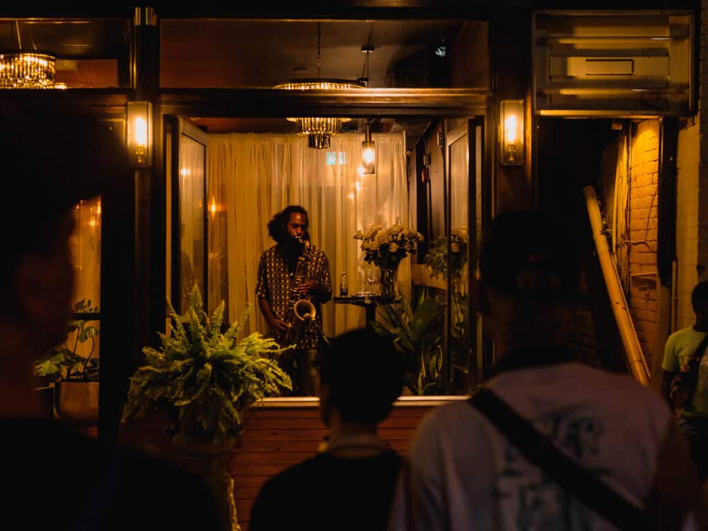 A jazz musician plays in a storefront